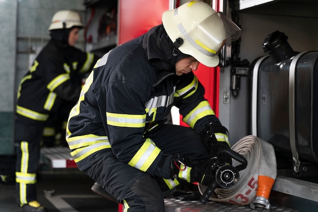 male-female-firefighters-working-together-suits-helmets_23-2149206389
